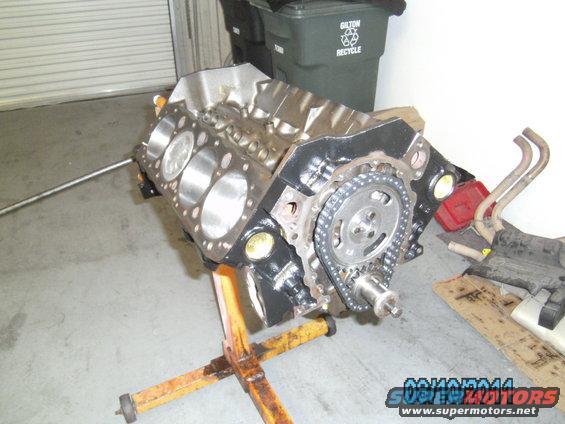 Engine block on stand with timing chain and gears visible