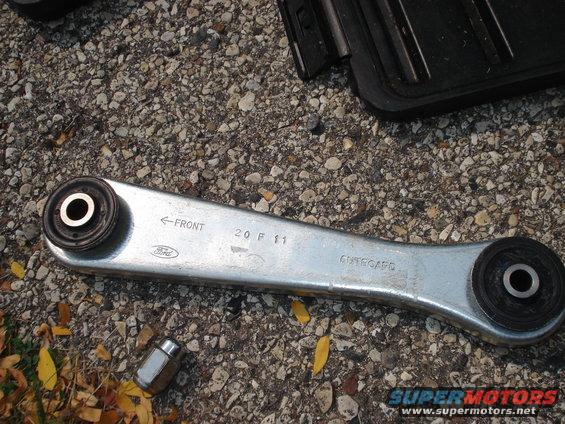 Ford rear control arm with 'FRONT' and '20 F 11' markings