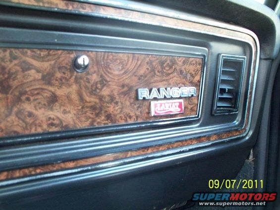 Wood-grain trim dashboard with RANGER Lariat badges and air vent