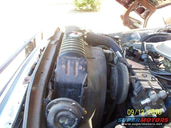 Engine bay with radiator, fan, and belts visible. Date stamp reads 09/12/2010