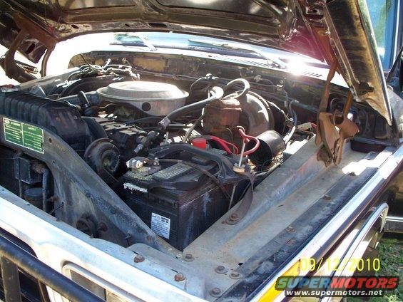 1979 Ford F-250 engine bay with battery and radiator visible