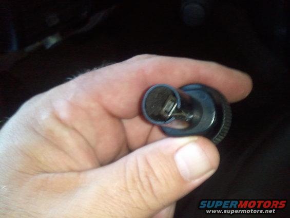 Hand holding a clock spring part