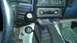 1989 Ford Bronco - The interior of a vehicle shows a manual transmission shifter and a transfer case shifter, along with an aftermarket stereo.