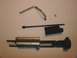 2003 Ford Crown Victoria - A disassembled firearm bolt carrier group, including springs and a rod, is laid out on a neutral surface.