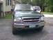 2000 Ford Ranger - Front view of a green Ford Ranger pickup truck with a license plate showing '99'.