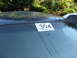 2003 Ford Crown Victoria - Auction lot number 304 is displayed on the windshield of a car, with another vehicle partially visible.
