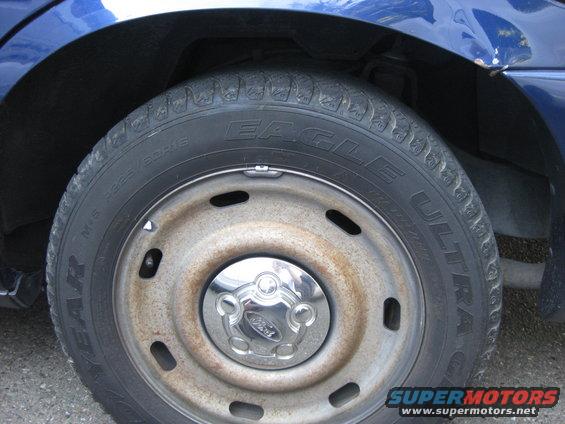 Blue 2003 Ford Crown Victoria wheel with Eagle Ultra tires and Ford center cap