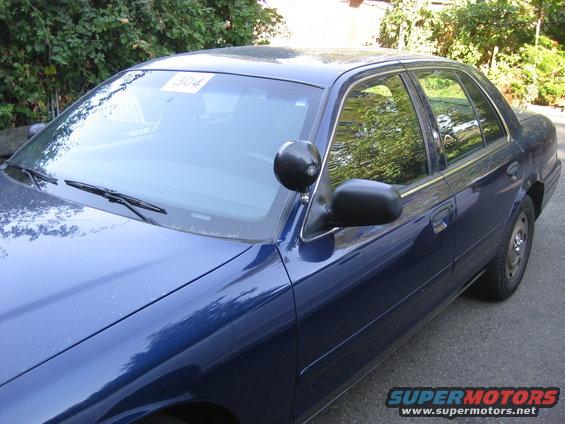 2003 Ford Crown Victoria sedan, driver's side front quarter view. Paper tag '304' on windshield