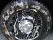 2003 Ford Crown Victoria - A truck wheel and tire are covered in soap suds, with a chrome hubcap visible in the center.
