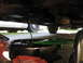 2003 Ford Crown Victoria - Oil change in progress with a catch pan positioned beneath the vehicle's drain plug.