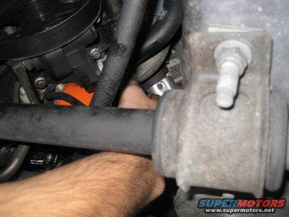 Engine part with hand reaching for it