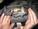 2003 Ford Crown Victoria - Hands are shown replacing a vehicle's fuel filter, a common maintenance task.