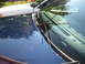 2003 Ford Crown Victoria - View of the hood and windshield of a dark blue 2003 Ford Crown Victoria, with another white vehicle visible in the background.