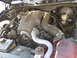 2003 Ford Crown Victoria - Close-up view of a vehicle's engine compartment, showing various components and hoses.