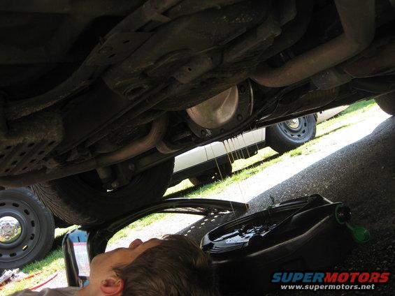 Underneath 2003 Ford Crown Victoria during oil change, showing differential and exhaust