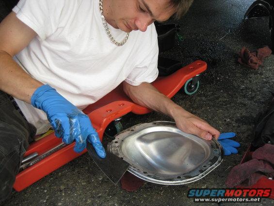 Man cleaning differential cover