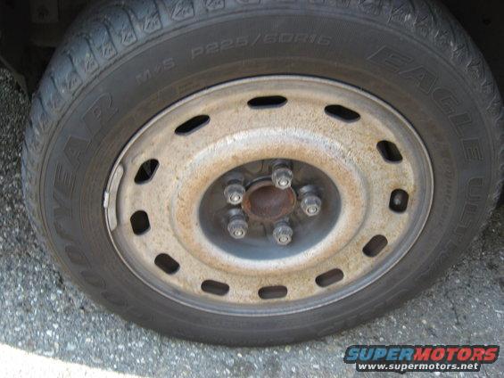Close-up of a Goodyear Eagle tire on a steel wheel with five lug nuts