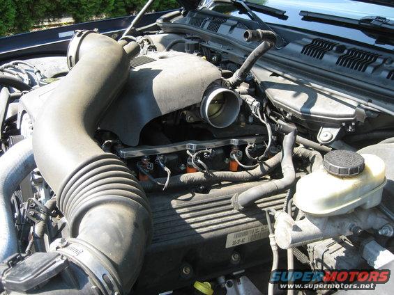 2003 Ford Crown Victoria engine bay showing air intake, throttle body, and fuel injectors