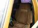1986 Ford Bronco - Interior view of a yellow vehicle, focusing on the brown cloth seat with a patterned insert.