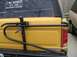 1986 Ford Bronco - Rear view of a yellow 1986 Ford Bronco, equipped with a Hi-Lift jack and a sticker for '2 Big Broncos 4x4 Club Southern Chapter'.