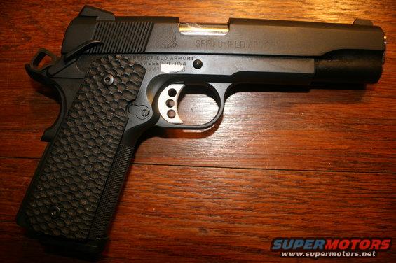 Springfield Armory 1911 pistol on a wooden surface