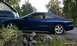 1994 Ford Probe - Side view of a blue 1994 Ford Probe GT with a green SUV partially visible.