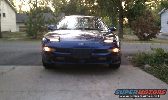 Blue 1994 Ford Probe front view with pop-up headlights up
