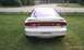 1994 Ford Probe - Rear view of a white 1994 Ford Probe GT parked on grass.