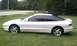 1994 Ford Probe - A white 1994 Ford Probe GT is parked on a grassy lawn with a second car visible in the background.