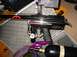 1986 Ford Bronco - A black paintball gun with a red design is shown next to a black air tank, with a purple mask in the foreground.
