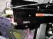 1986 Ford Bronco - Close-up of a black paintball gun, showing its serial number and brand name.