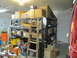 1993 Ford F-250 - A cluttered garage scene with storage shelves filled with various items and a ladder.