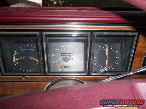 Car dashboard with fuel gauge, speedometer, and clock. Odometer shows 203745