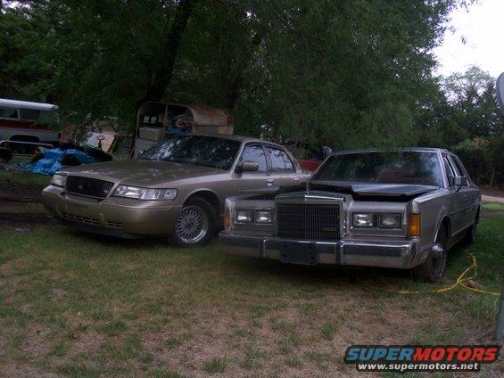 Gold 1998 Mercury Grand Marquis and silver Lincoln Town Car parked side-by-side
