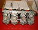 1999 Kawasaki H2C - Mikuni RS Series Radial Flat Slide Carburetors are shown on a red surface with their documentation in the background.