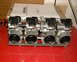 1999 Kawasaki H2C - A set of Mikuni RS series flatslide carburetors is displayed on a red surface with a document in the background.