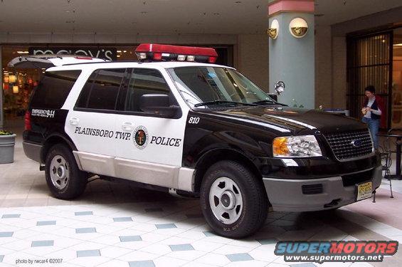 Black and white Plainsboro Twp. Police SUV parked inside a mall, emergency lights on roof