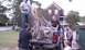 1979 Ford Bronco - Several people are working together to load scrap wood into the back of a pickup truck.