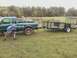 2000 Ford Ranger - A man poses with his green pickup truck and trailer loaded with firewood.