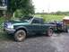 2000 Ford Ranger - A green 2000 Ford Ranger pickup truck is seen from the front-three-quarter angle, towing a trailer loaded with ATVs.
