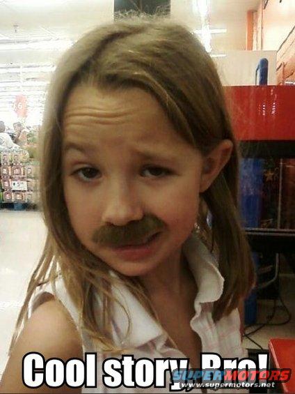 Girl wearing a fake mustache and looking unimpressed