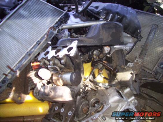 Engine block, oil pan, exhaust manifold, and radiator piled together