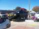1989 Ford Bronco - Modified pickup truck with kayak on roof rack parked next to other vehicles at an outdoor event.