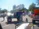 1989 Ford Bronco - A customized Jeep CJ and an orange Ford Bronco are parked at an outdoor event.