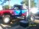 1989 Ford Bronco - This heavily modified pickup truck features custom graphics and large off-road tires, suggesting it's built for off-roading.
