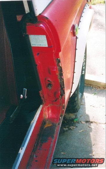 1974 Ford Bronco door jamb showing rust damage and white fender flare with 'DIGGER' text