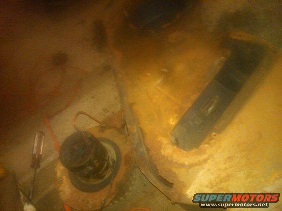 close-up of rusty interior floor with some parts and wires