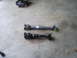 1992 Ford Bronco - Two driveshafts are laid out on a concrete surface, one appears to be a replacement part.