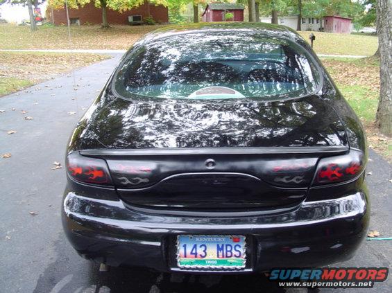 Black 1999 Ford Taurus sedan, rear view, with custom flame taillights and Kentucky license plate