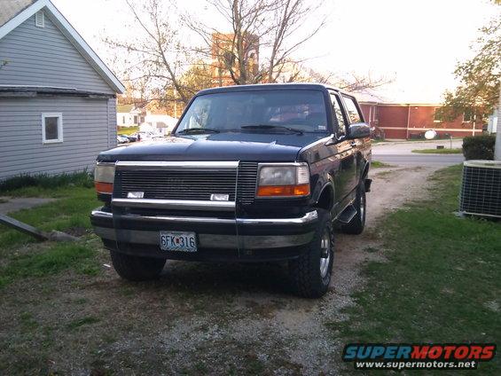 1994 Ford Bronco front grille and headlights. Dark blue SUV